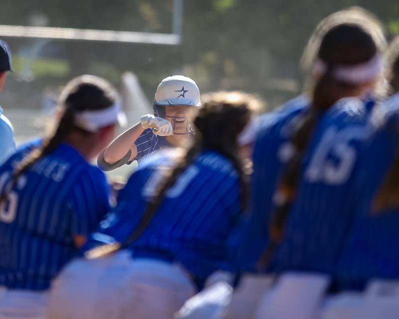 St Charles North's Julia Larson (4) is greeted at the plate after hitting a homerun during the Class 4A Glenbard West Regional Final softball game between Glenbard North at St Charles North.  May 26, 2023.