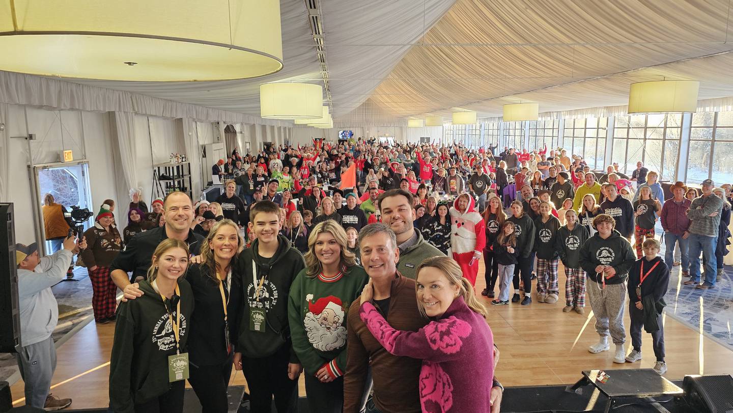 Cailyn, Mike, April and Charlie Missak stand for a photo with Gabrielle, Ray III, Ray Jr. and Lisa Scarpelli as the crowd at the Jeeps on the Run Toys for Tots Run after-party celebrates Dec. 7.