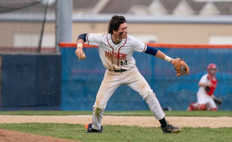 Oswego’s Trey Hernandez (14) throws to second base for a force out against Plainfield South during a baseball game at Oswego High School on Monday, April 11, 2022.