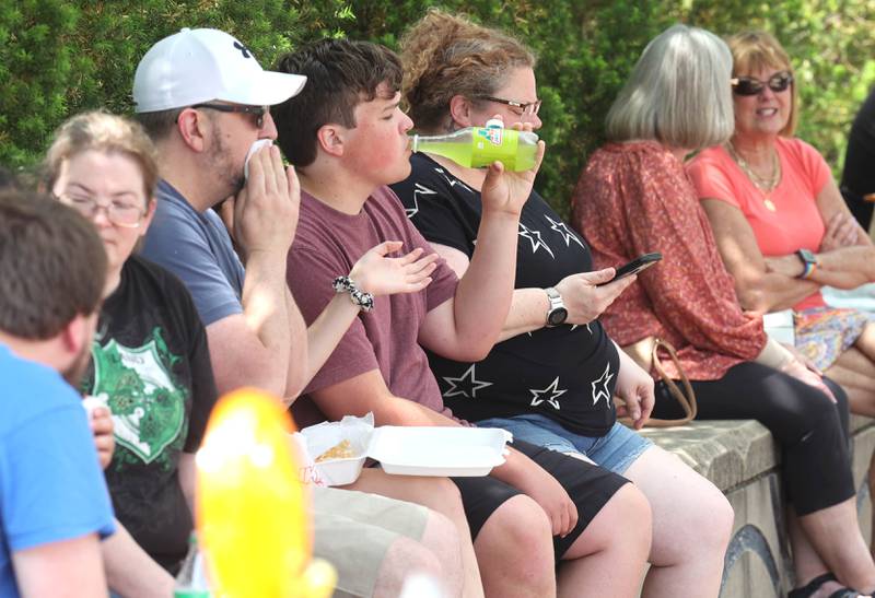 Patrons stop to eat and have a drink on a warm Thursday afternoon during opening day for the DeKalb Farmers Market Thursday, June 1, 2023, at Van Buer Plaza in downtown DeKalb. The Farmers Market is open every Thursday from 10 am to 2 pm through September 21.