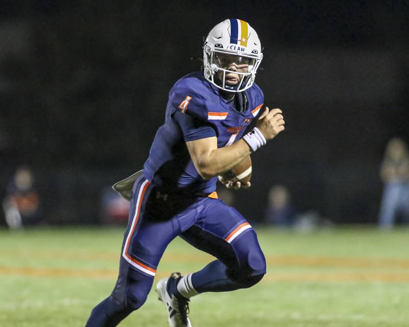 Oswego's Drew Kleinhans (4) is chased to the sidelines during football game between Bolingbrook at Oswego Friday, Sept 12, 2025  in Oswego.