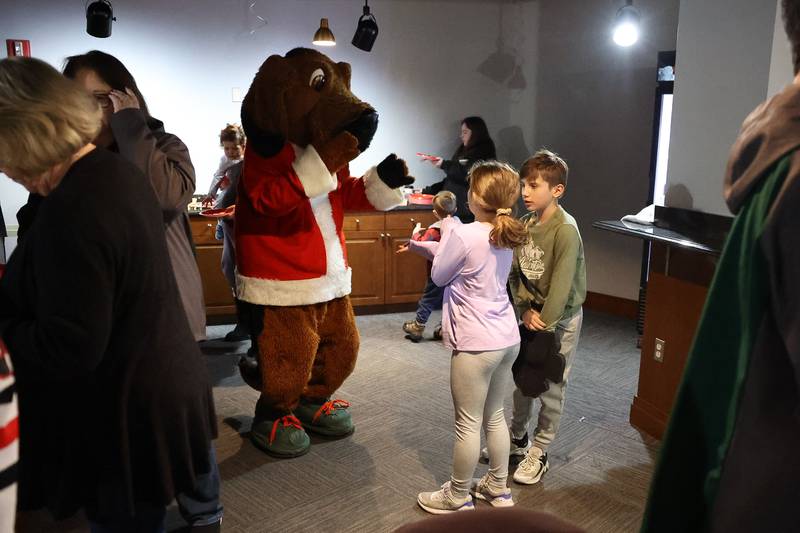 Slammers mascot Spike has fun with a couple young fans at the Joliet Slammers annual Holiday Open House on Saturday, December 2nd at Duly Health and Care Field in Joliet.