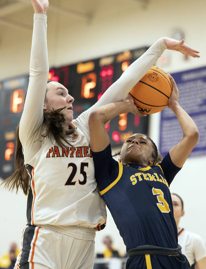 Sterling’s Delali Amankwa is fouled by Washington’s Danielle Guedet Monday, March 3, 2025, during the 3A Supersectional at Rochelle High School.