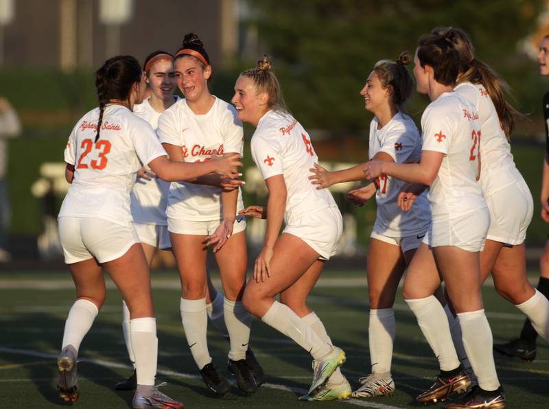 St. Charles East players celebrate Grace Williams’ goal during a game at Wheaton Warrenville South on Tuesday, April 18, 2023.
