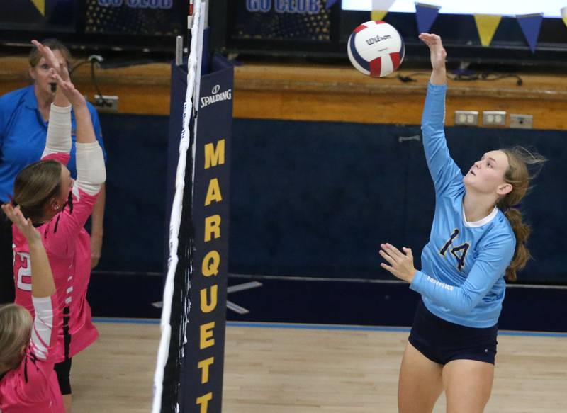 Marquette's Taylor Gamons spikes the ball against Serena on Wednesday, Oct. 22, 2025 in Bader Gymnasium at Marquette High School.