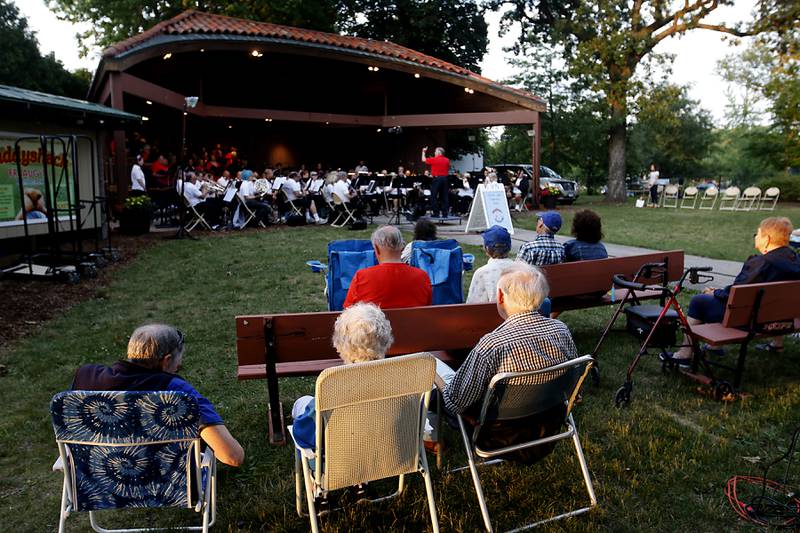 People listen to the Crystal Lake Community Band and Voices in Harmony perform before the fireworks show Sunday, July 2, 2023, at Crystal Lake’s Main Beach during Crystal Lake Annual Independence Day Celebration.