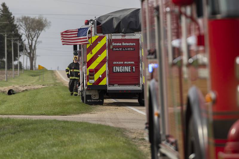 Firetrucks line Harmon Road Monday, April 14, 2025, in rural Lee County to battle a blaze.