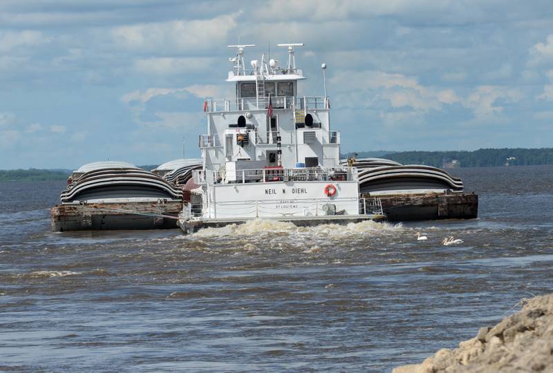 The Neil and Diehl towboat pushes barges north on the Mississippi River after passing through the lock at Lock & Dam 13 near Fulton on Sunday, July 6, 2025.