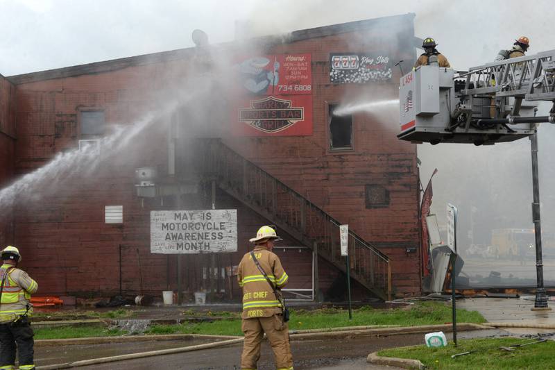 Firefighters from several deapartments responded to  structure fire at the corner of Main Street and Wesley Avenue in downtown Mt. Morris on Tuesday, April 16, 2024. The wooden structure housed two apartments and Sharky's Sports Bar. Fire crews battled high winds during the afternoon blaze.