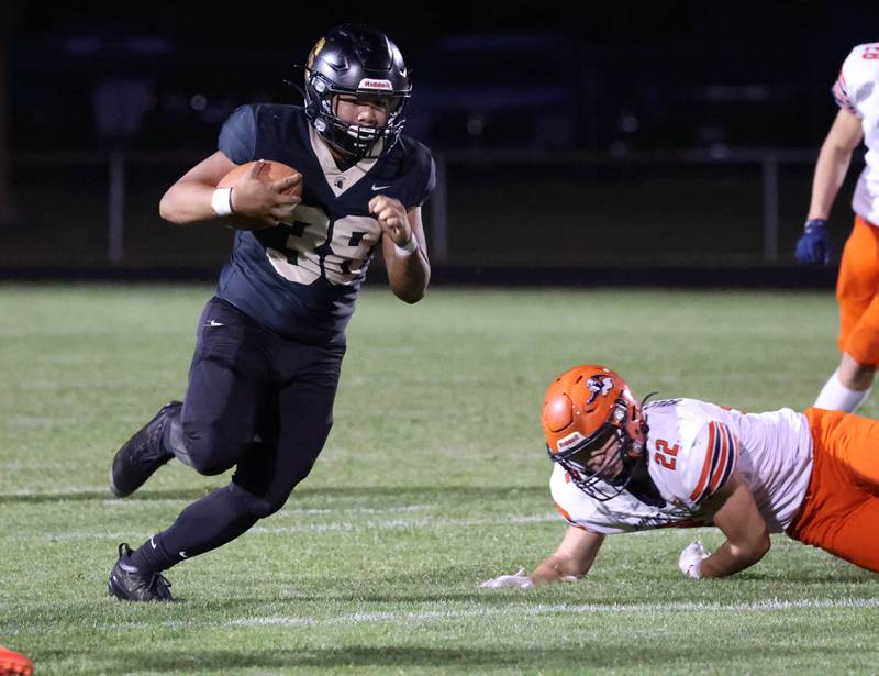 Sycamore's Jayson Panganiban runs by Mahomet-Seymour's Beau Back during their game Friday, Sept. 12, 2025, at Sycamore High School.