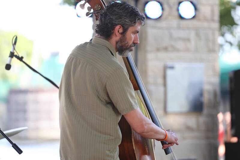 A bass player jams with the Chris Greene Quartet at the Wine, Jazz and Arts Fest at Bicentennial Park in Joliet on Saturday, Aug. 19, 2023.