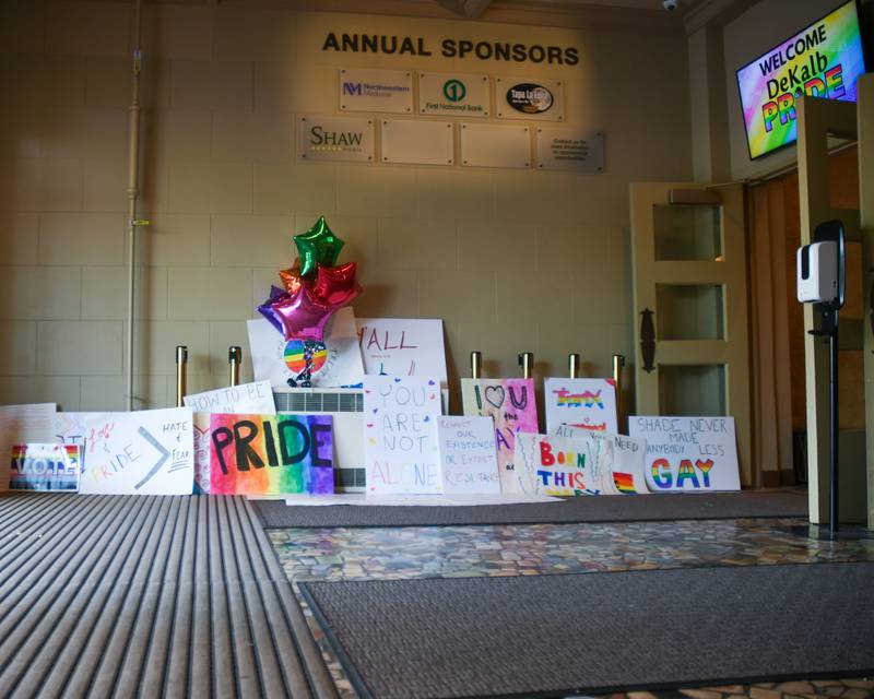 Encouraging signs sit in the foyer of the Egyptian Theater in DeKalb while a screen welcomes DeKalb Pride Fest goers during the annual event held in downtown DeKalb on Thursday, June 22, 2023.