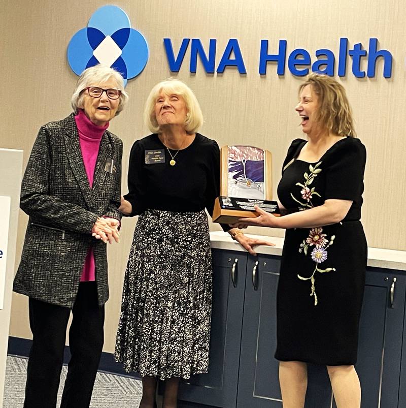 VNA Health Care board member Miriam Smith (center) and President and CEO Linnea Windel (right) present former President and CEO Janet Craft (left) with the first ever Janet S. Craft Award of Quality during a reception at the VNA headquarters in Aurora on Oct. 24, 2024.