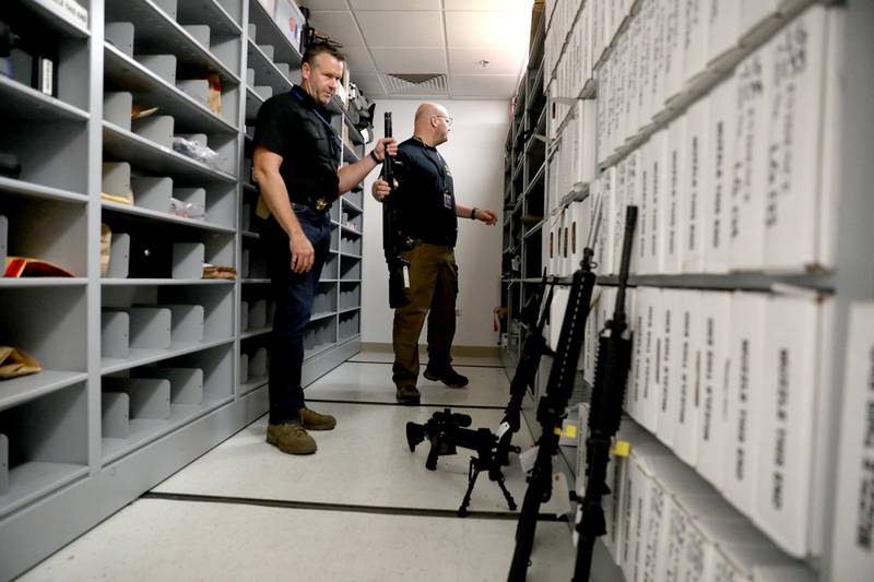 Kane County Sheriff Ron Hain and Det. Dave Thorgesen, evidence technician, show some of the weapons the department has in storage that were obtained due to domestic violence reports and orders of protection.