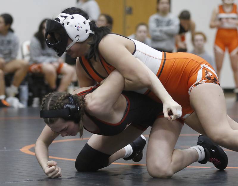 McHenry’s Natalie Corona tries to control Huntley’s Jessica Olson during the 140-pound match of a Fox Valley Conference girls wrestling match Thursday, Jan. 11, 2024, at McHenry High School.