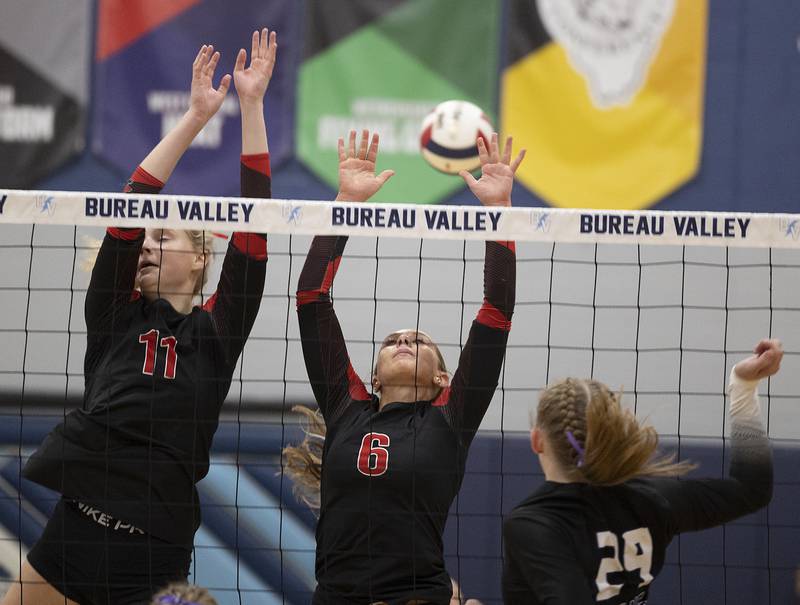 Erie-Prophetstown’s Lauren Abbott (left) and Jamie Neumiller go up for a block against El Paso-Gridley Thursday, Nov. 7, 2024, during the class 2A volleyball sectional championship at Bureau Valley High School.