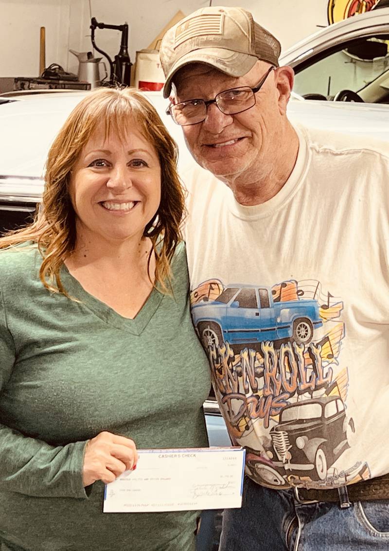 Chuck Reynolds of Peru presents a $1,800 check to Betty Glynn of Cops 4 Cancer, Inc. Reynolds and his family organize the Cruisin’ Against Cancer Car Show at the Rootbeer Stand in Oglesby and have raised close to $27,000 for Cops 4 Cancer, Inc. from the past 10 shows.