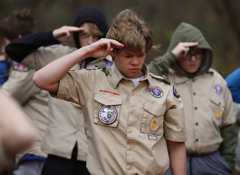 A boy scout from Batavia Troop 6 salutes as a flag is retired during the Annual Veterans Day Scout VFW vigil and flag retirement ceremony at Overseas VFW Post 1197 in Batavia on Saturday Nov. 5, 2022.