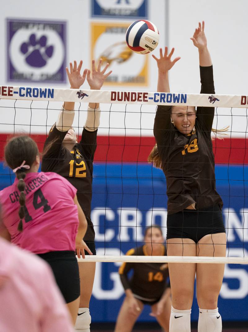 Jacobs' Gianna Coletti and Gracyn Sanders jump to block a shot from Dundee-Crown's Kate Graham during their game on Thursday, October 16, 2025 at Dundee-Crown High School in Carpentersville. Ryan Rayburn for Shaw Local