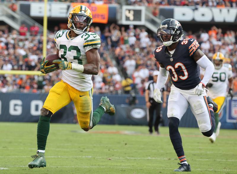 Green Bay Packers running back Aaron Jones coasts in for a touchdown ahead of Chicago Bears cornerback Jaylon Johnson during their game Sunday, Sept. 10, 2023, at Soldier Field in Chicago.