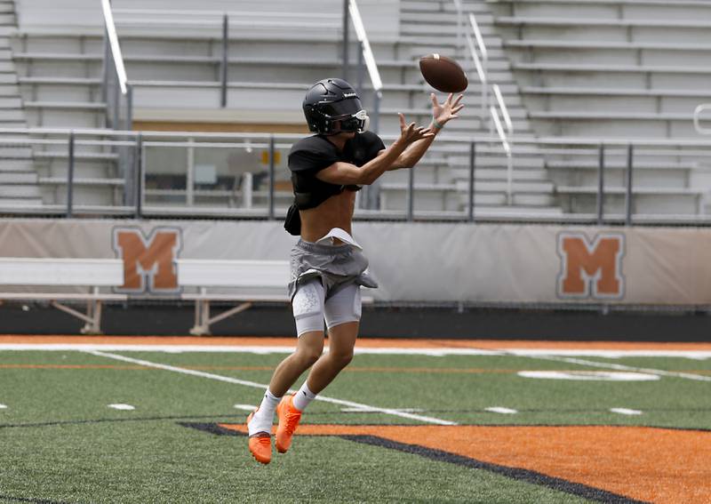 McHenry’s Dayton Warren catches a pass during football practice on Thursday, July 24, 2025, at McCracken Field, in McHenry.