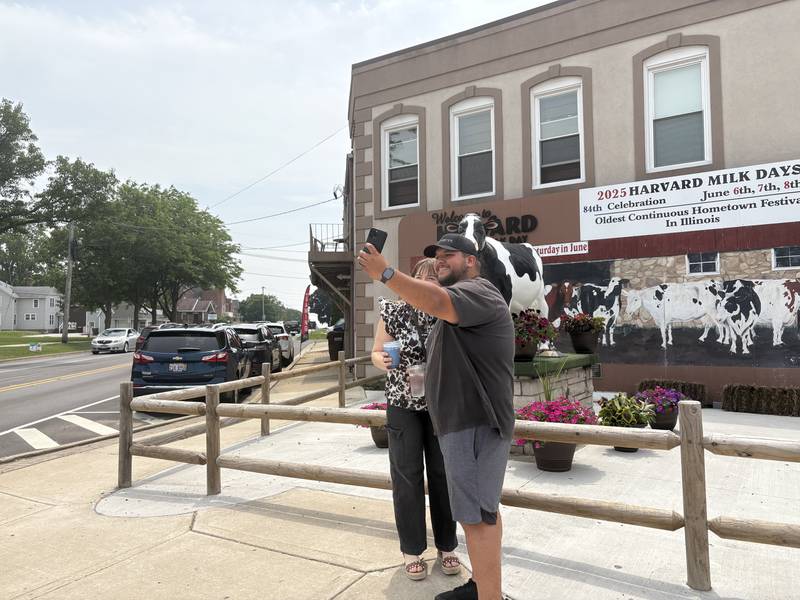 Irina Bezuglova, left, and David Enriquez take a picture with Harmilda before the Harvard Milk Days parade June 7, 2025.
