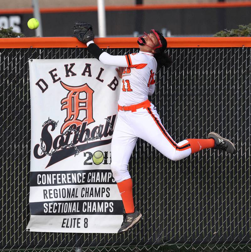 DeKalb's Sydney Myles can‚Äôt quiet make the catch on a Naperville Central home run Wednesday, April 16, 2025, during their game at DeKalb High School.