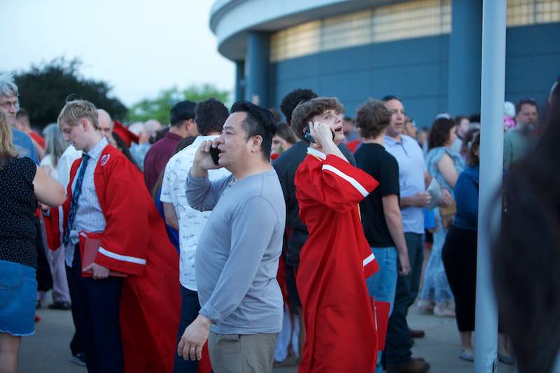 Yorkville High School Graduates and families call to find each other after Commencement Ceremony at NIU Convocation Center on Friday, May 16, 2025 in DeKalb.