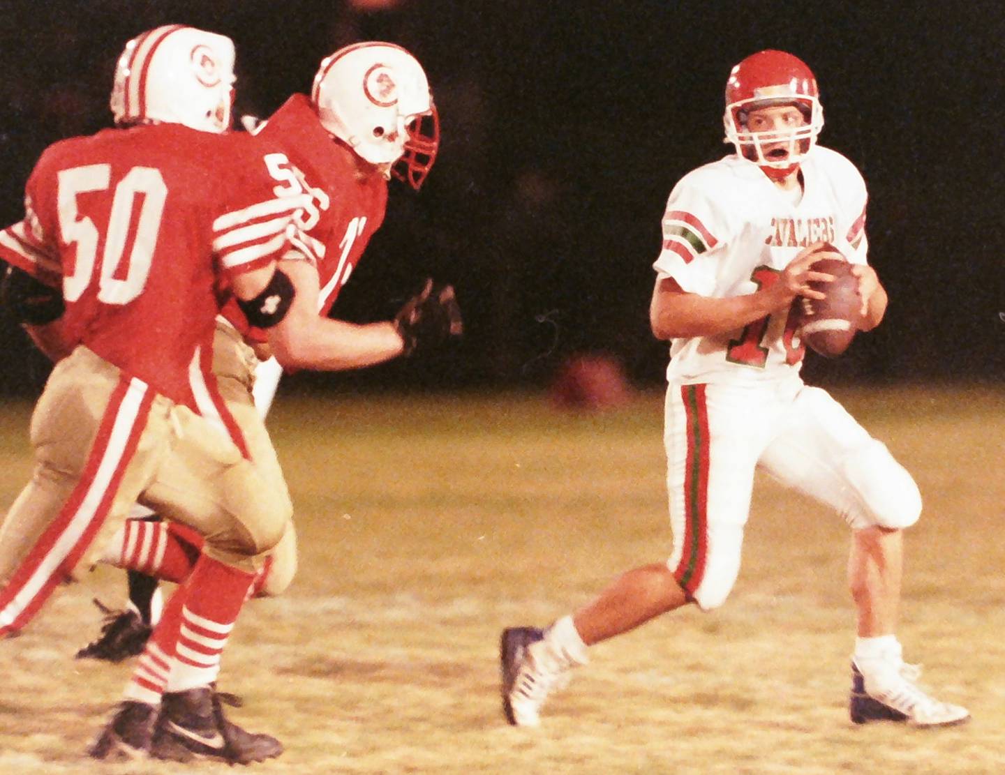 La Salle-Peru quarterback Eric Robertson looks to pass the ball as Ottawa defenders Brian Billings (50) and Wayne Johnson (76) look to sack him on Friday, Oct. 23, 1992 at King Field in Ottawa.