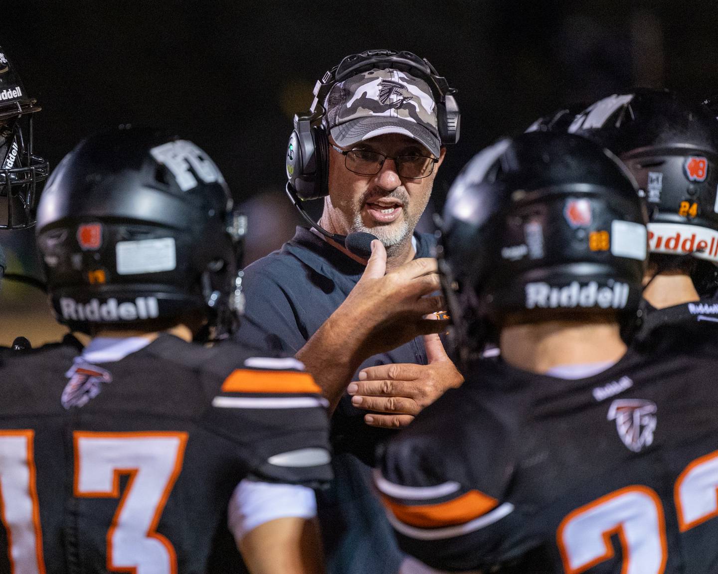 Head Coach of FCW, Todd Reed talks with team in huddle on Friday, Sept. 26, 2025, at Woodland School in rural Streator.
