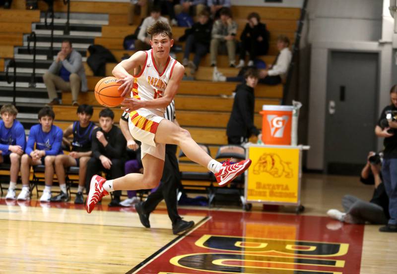 Batavia’s Dane Farrar leaps to keep the ball inbounds during a game against St. Charles North on Wednesday, Dec. 11, 2024 in Batavia.