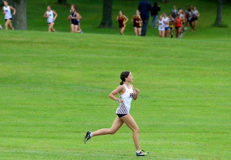 Prairie Ridge’s Emaline Foster sprints out to an early lead in the girls varsity race of the McHenry County Cross Country Meet at Emricson park in Woodstock on Saturday, August 30, 2025.