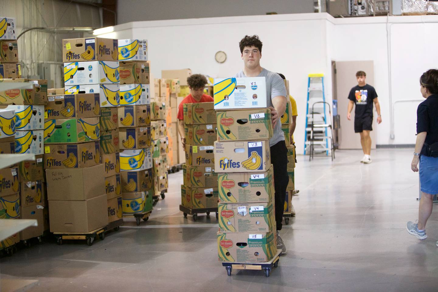 Batavia High School Football players help move boxes out of the former location of the Batavia Food Pantry on Saturday, Sept. 27,2025 in Batavia.