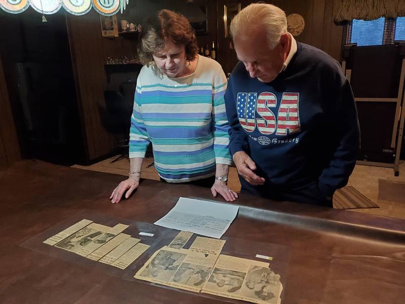 Diana and Robert Ceci of Joliet look through old clippings from The Herald-News that Robert's mother Beverly Ceci had saved and laminated. These clippings are the only record Robert has of his father David Ceci's military service. David Ceci and four of his brothers had all served in the Army during World War II. One was killed in action and another was pronounced missing in action but later came home.