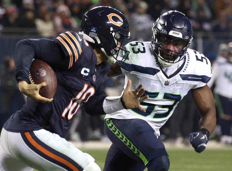 Chicago Bears quarterback Caleb Williams tries to get by Seattle Seahawks linebacker Boye Mafe during their game Sunday, Dec. 26, 2024, at Soldier Field in Chicago.