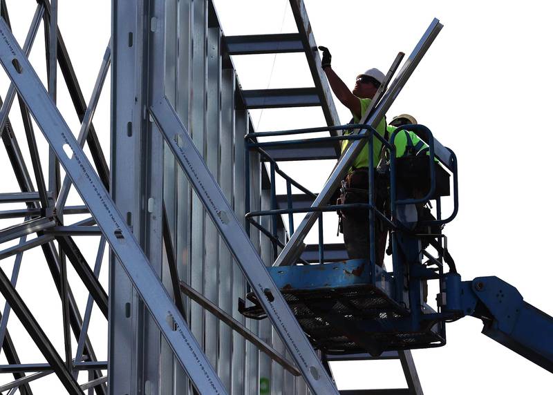 Irving Construction employees work on the roof of the new DeKalb fire station Wednesday, Sept. 18, 2024, at 1130 South Malta Road in DeKalb. Construction on the station, the fourth for the DeKalb Fire Department, is ongoing.