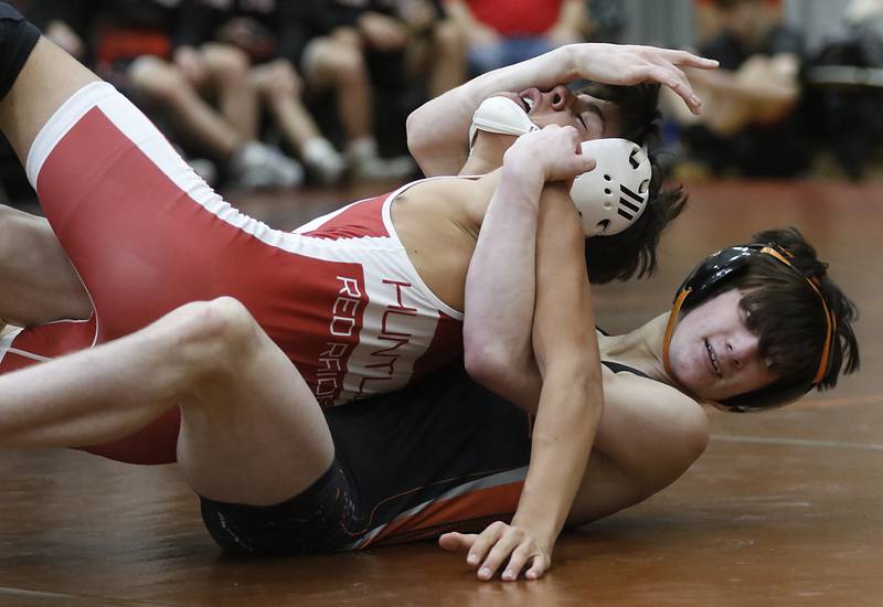 McHenry’s Ryan Hansontries to take down Huntley’s Julian Gutierrez during the 120-pound match of a Fox Valley Conference boys wrestling match Thursday, Jan. 11, 2024, at McHenry High School.