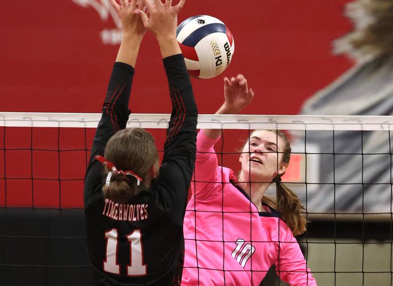 Hiawatha's Delaney Wood spikes the ball into Indian Creek's Ellie Bend during their match Tuesday, Oct. 15, 2024, at Indian Creek High School in Shabbona.