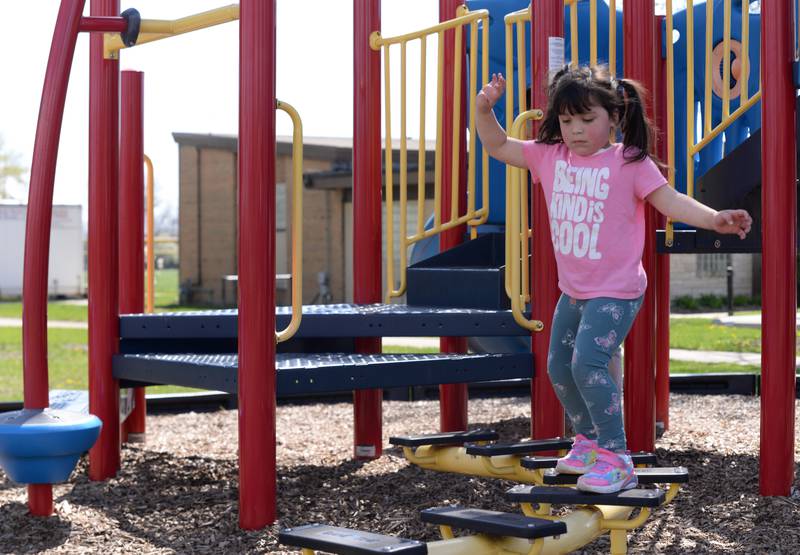 Children including June Boland of Berwyn play on the playground at Sedgwick Park Sunday, April 14, 2024.