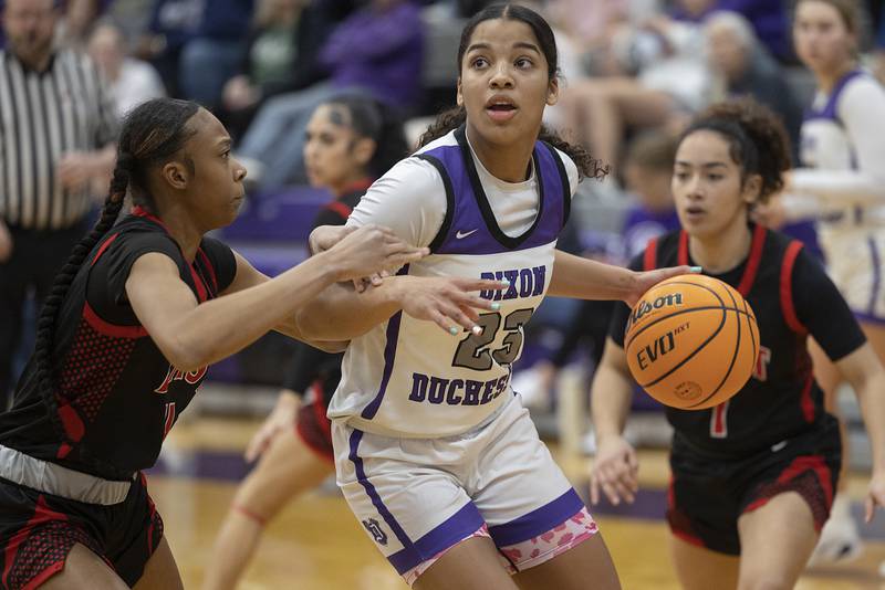 Dixon’s Ahmyrie McGowan works against Rockford East’s J’Lynn Sims Monday, Feb. 16, 2026.