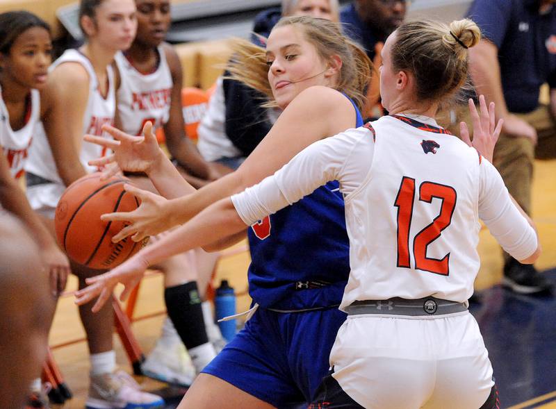 Glenbard South's Kate Bruhl loses the handle on the ball under pressure from Oswego defender Emily Mengerink (12) during a girls varsity basketball game at Oswego High School on Wednesday, Nov. 16, 2022.