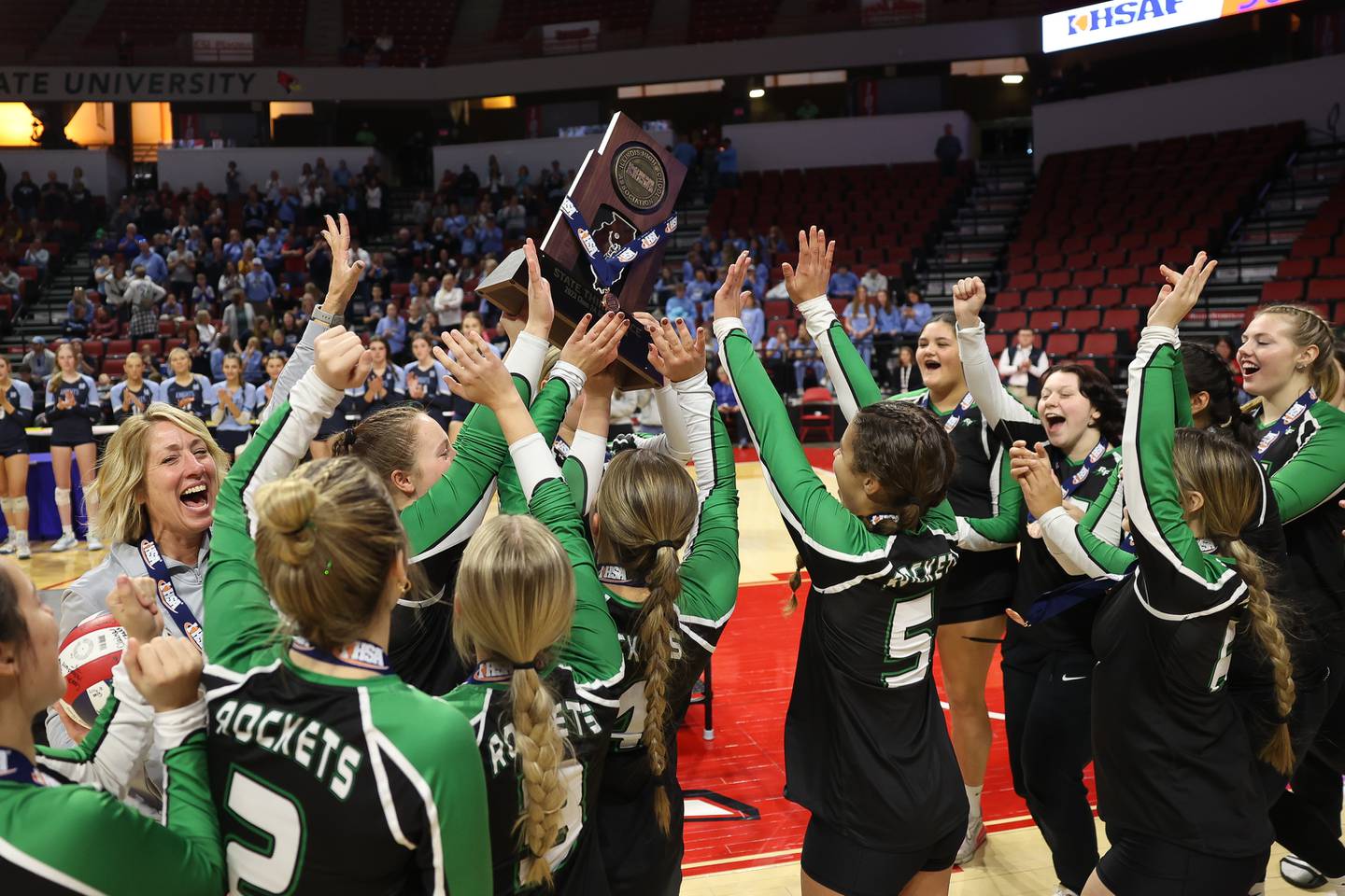 Rock Falls holds up the Class 2A Third Place trophy after the Rockets win against Carmi-White County in the Class 2A Volleyball Third Place match on Saturday, Nov. 11, 2023 in Normal.