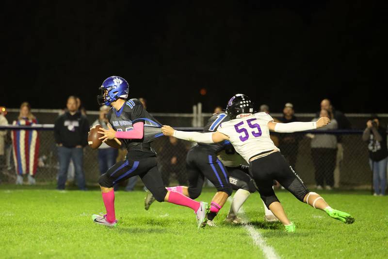Peotone's Alex Chenoweth looks to pass as Manteno's Tommy Lawlor grabs on for the tackle during the Blue Devils' 25-20 loss to Manteno on Friday, Oct. 17, 2025, in the annual Rumble on Route 50 rivalry game.