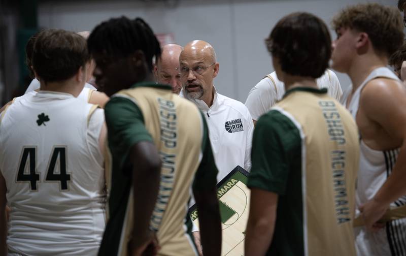 Bishop McNamara's head coach Adrian Provost, center, talks with his team between quarters in a game against Chicago Bulls Prep on Friday, December 19, 2025.