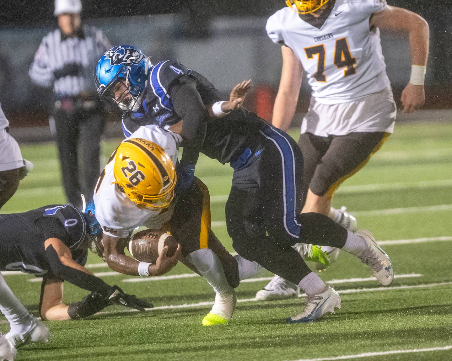 Carmel's Jaquel Edmonds is tackled by St. Charles North's Wyatt Brandt at the Class 7A Second Round playoff game on Saturday, Nov.8,2025 in St. Charles.