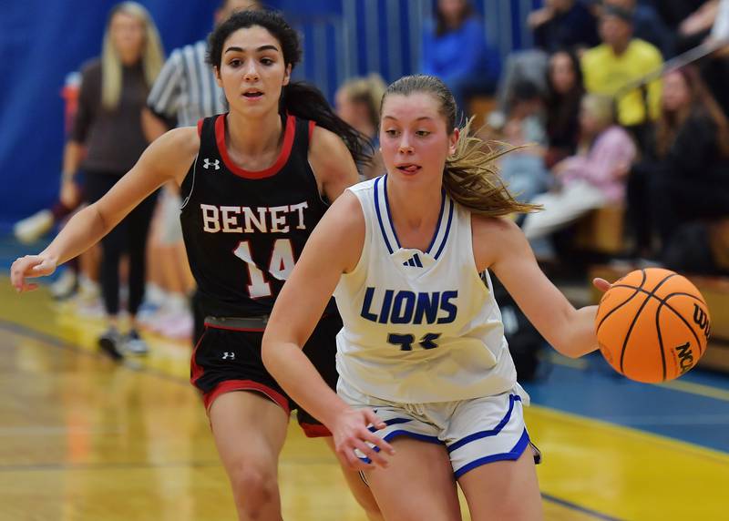 Lyons Township's Gwen Smith drives past Benet's Audrey Panoushis (14) during a game on November 19, 2024 at Lyons Township High School in LaGrange.
