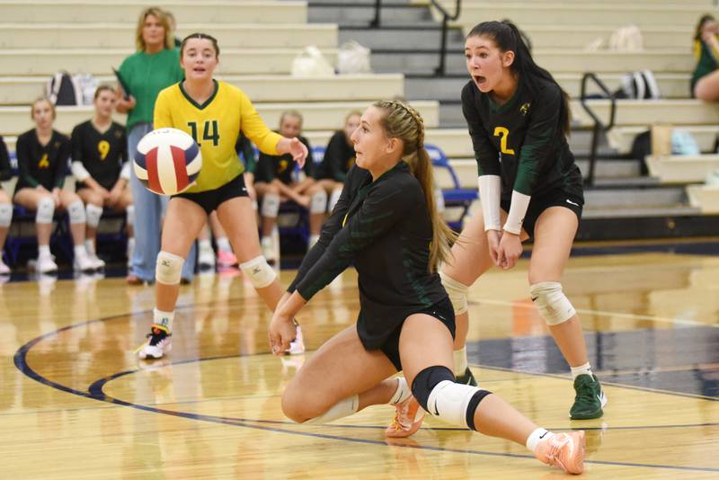Coal City's Ava Kenney, center, digs the ball in front of teammates Olivia Ferrari (14) and Keirsten Gabehart during a game at Peotone Thursday, Sept. 18, 2025.
