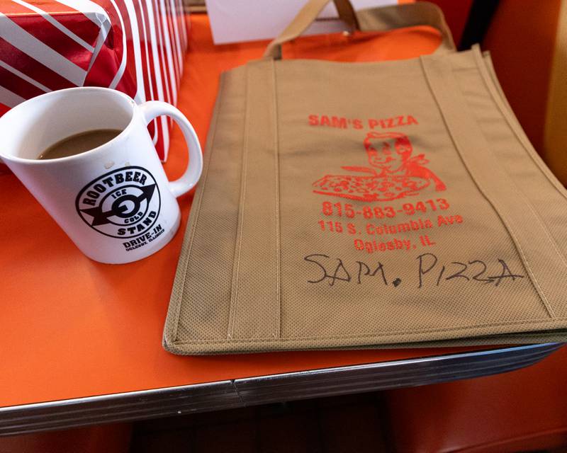 A signed Sam’s Pizza tote bag sits on table at Sam’s retirement celebration on Saturday, October 25, 2025 at the Rootbeer Stand in Oglesby.