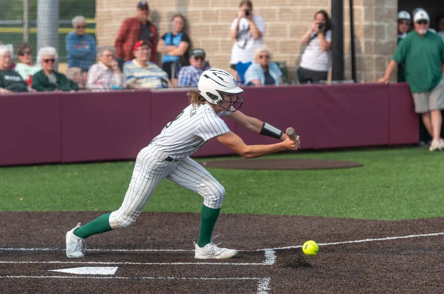 St. Bede's Lily Bosnich drops down a bunt in Friday's sectional softball championship game in Chillicothe.