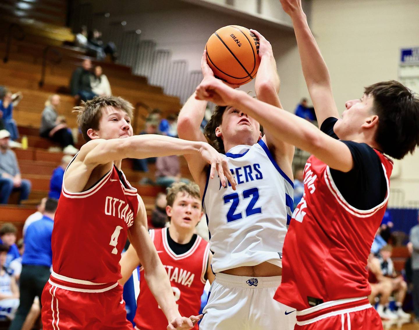 Princeton's Deacon Gutshall finds himself in a pickle between Ottawa's Black Schiltz (4) and Dom Parks Tuesday night at Prouty Gym. The Pirates won 73-43.